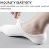 A close-up of a white invisible silicone no-show boat sock being worn on a foot.