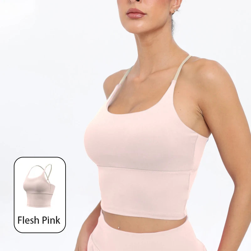 A model wearing a light pink summer strappy yoga sports bra with built-in padding.