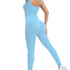 A woman wearing a light blue ribbed nylon bodycon jumpsuit with a high neck and long sleeves.