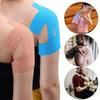Close-up of a pink elastic patch applied to a person's shoulder for pain relief.