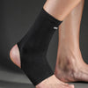 A close-up of a black ankle support brace worn on a person's lower leg.