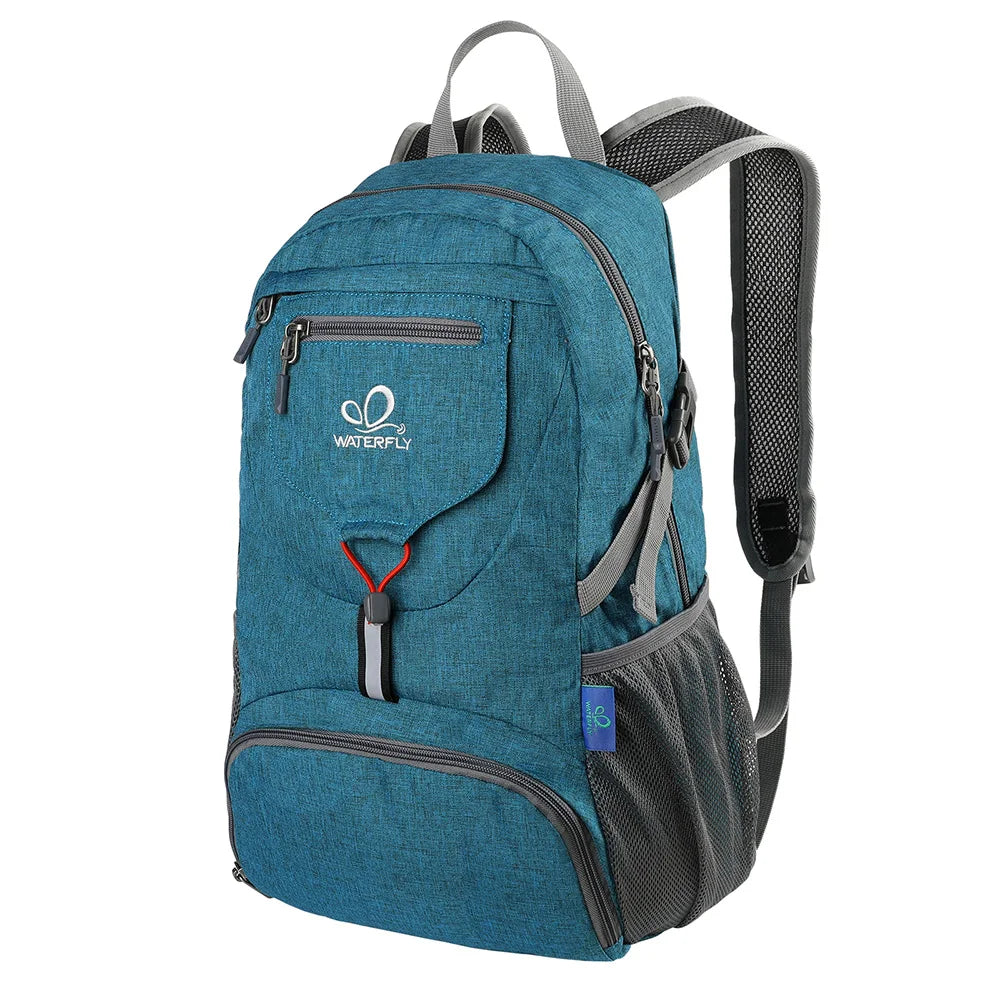 A teal foldable travel backpack with gray straps and pockets.