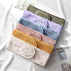 A stack of colorful faux fur and acrylic hair accessories in various pastel and earthy tones.