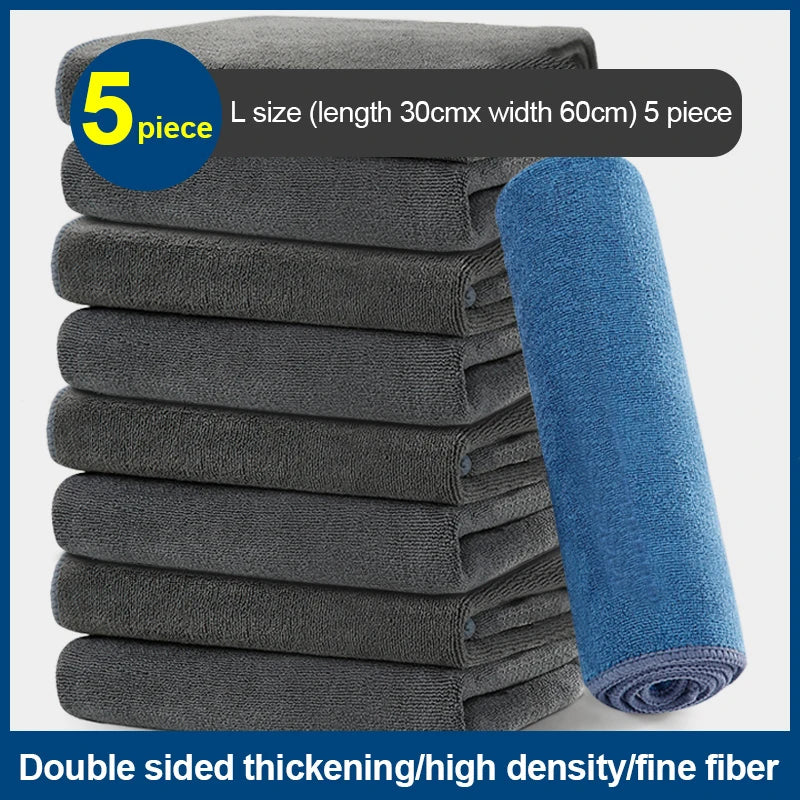 A stack of five gray microfiber car cleaning towels with a blue towel lying beside them.