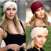 A woman models a beige elastic sports headband worn across her forehead and hair.