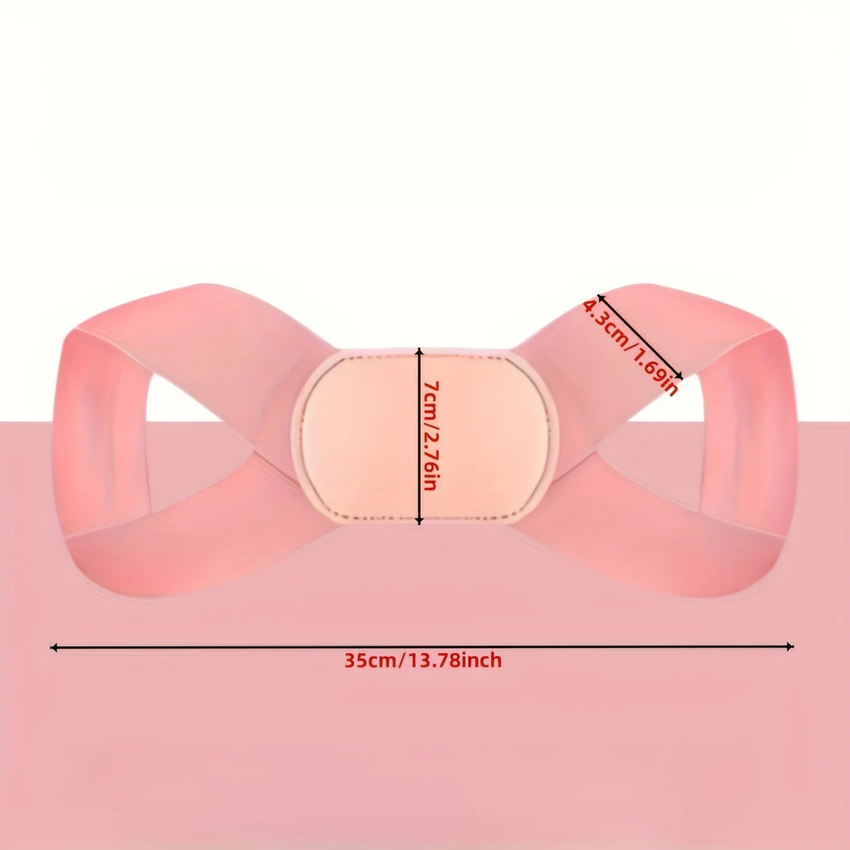 A pink adjustable posture corrector belt shown flat on a surface with measurements for size.