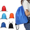 A collection of various blue, red, orange, and black drawstring storage bags shown next to a person's arm.