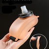 A hand holds a translucent orange sports water bottle in a full water state, demonstrating its ability to return to a gas sta