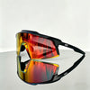 A pair of orange-tinted sports sunglasses with black frames resting on a white surface.