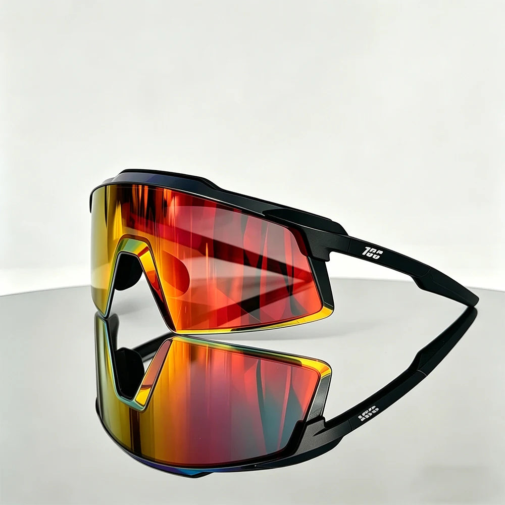 A pair of orange-tinted sports sunglasses with black frames resting on a white surface.