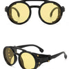 Black sunglasses with yellow lenses and gold accents
