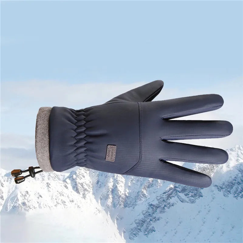 A dark blue extreme cold-proof ski glove is shown against a snowy mountain background.