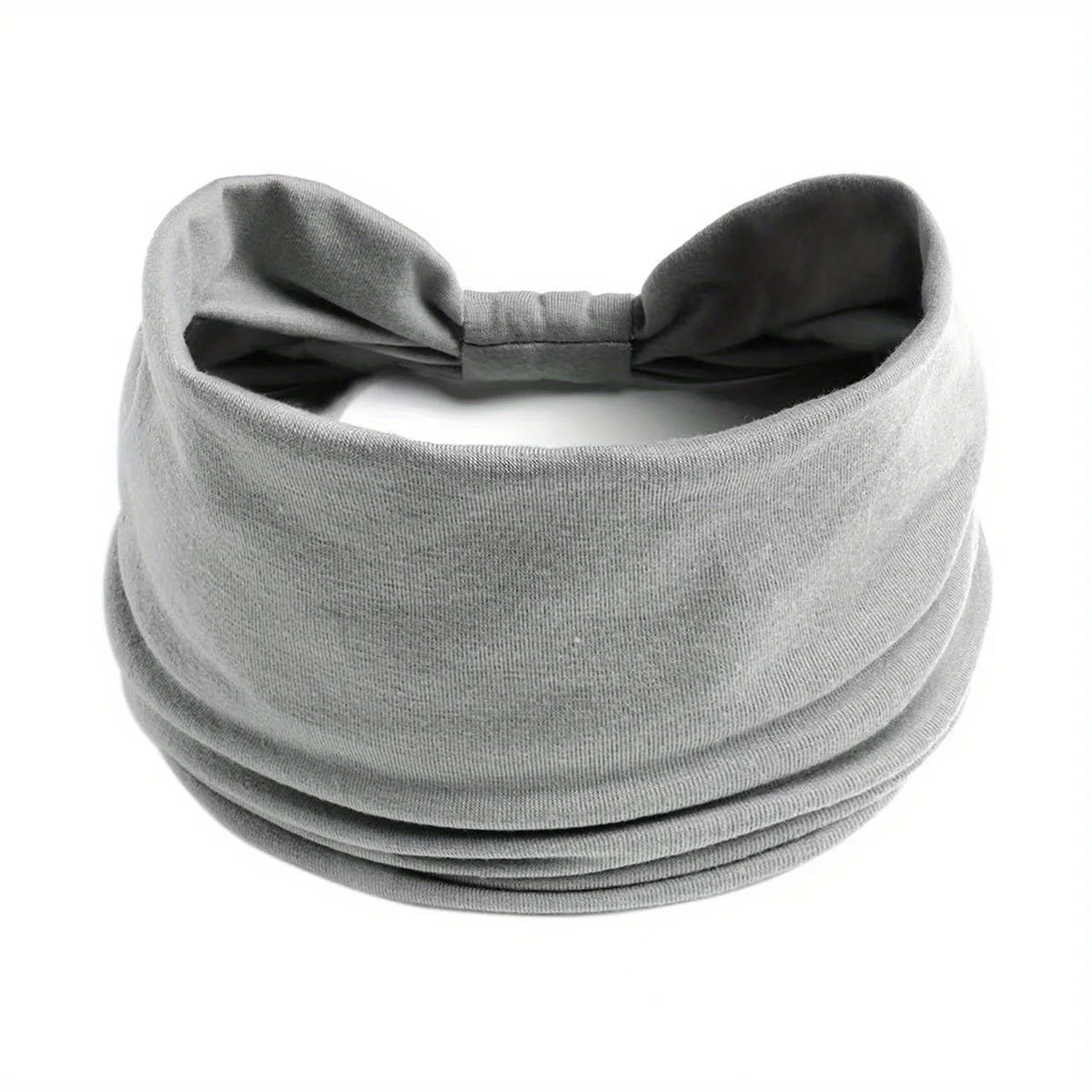 Diadema ancha y elástica gris para el cabello y deportes, doblada y mostrada plana.