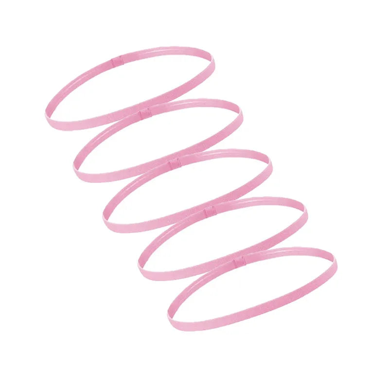 A set of five pink multi-functional elastic sports headbands coiled in a spiral pattern.