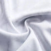 A close-up of a white esports team jersey fabric draped and folded