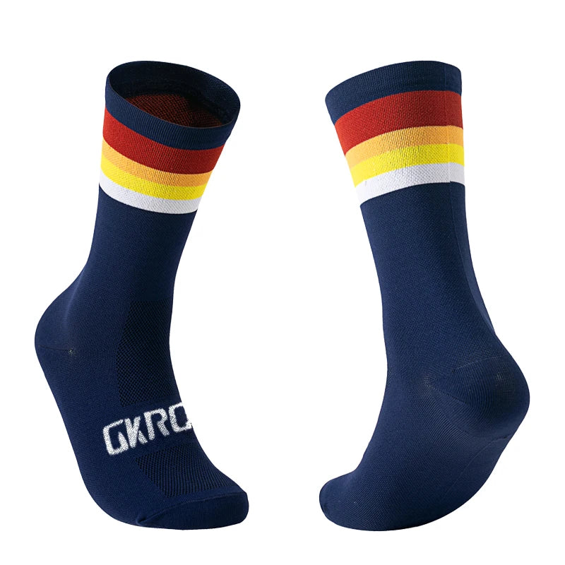 A pair of navy blue cycling socks with a striped cuff featuring red, orange, yellow, and white bands.