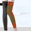 A pair of orange and green patterned non-slip elastic knee sleeves shown on a leg.