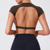 A woman wearing a dark brown women's fitness crop top yoga and gym t-shirt, shown from the back.
