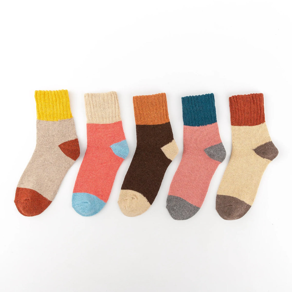 A row of ten knitted crew socks in various earthy and muted colors laid out horizontally.