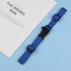 A blue tactical backpack strap harness is displayed next to a book titled The Wrong Man.
