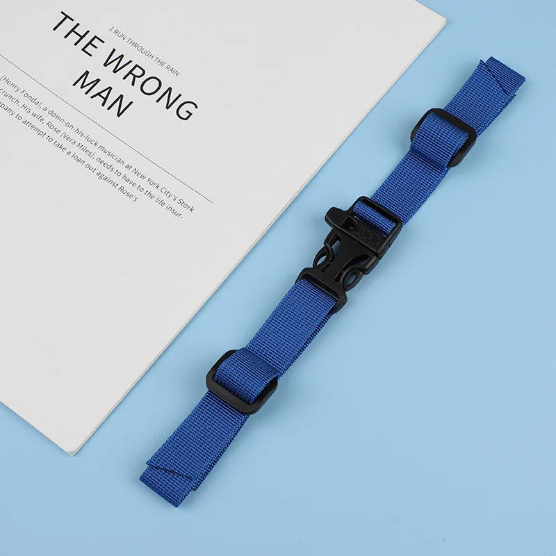 A blue tactical backpack strap harness is displayed next to a book titled The Wrong Man.