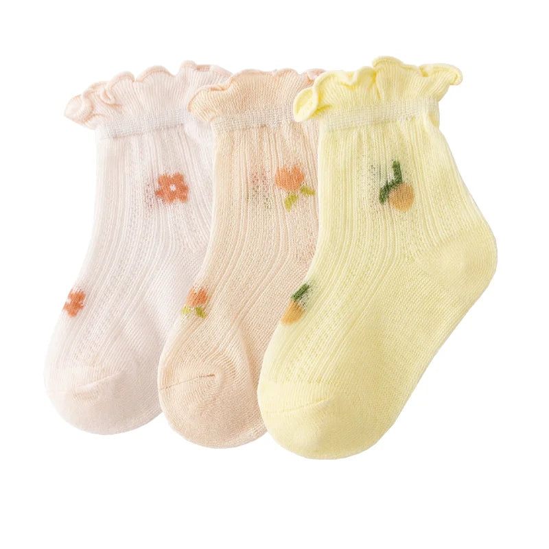 A pack of three thin summer casual baby socks in pink, beige, and yellow.