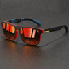 Vintage designer square sunglasses with black frames and orange-tinted lenses resting on a dark surface.