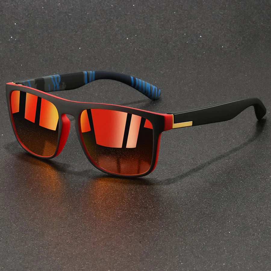 Vintage designer square sunglasses with black frames and orange-tinted lenses resting on a dark surface.