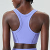 A model wearing a lavender high-impact stretch yoga crop top from the back view.