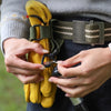 Hands are adjusting a tactical nylon glove hook for storage or climbing.