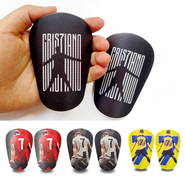 Black mini football shin guards shown in hand and multiple views