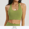 A model wearing a lime green halter neck sports bra top for yoga or gym activities.