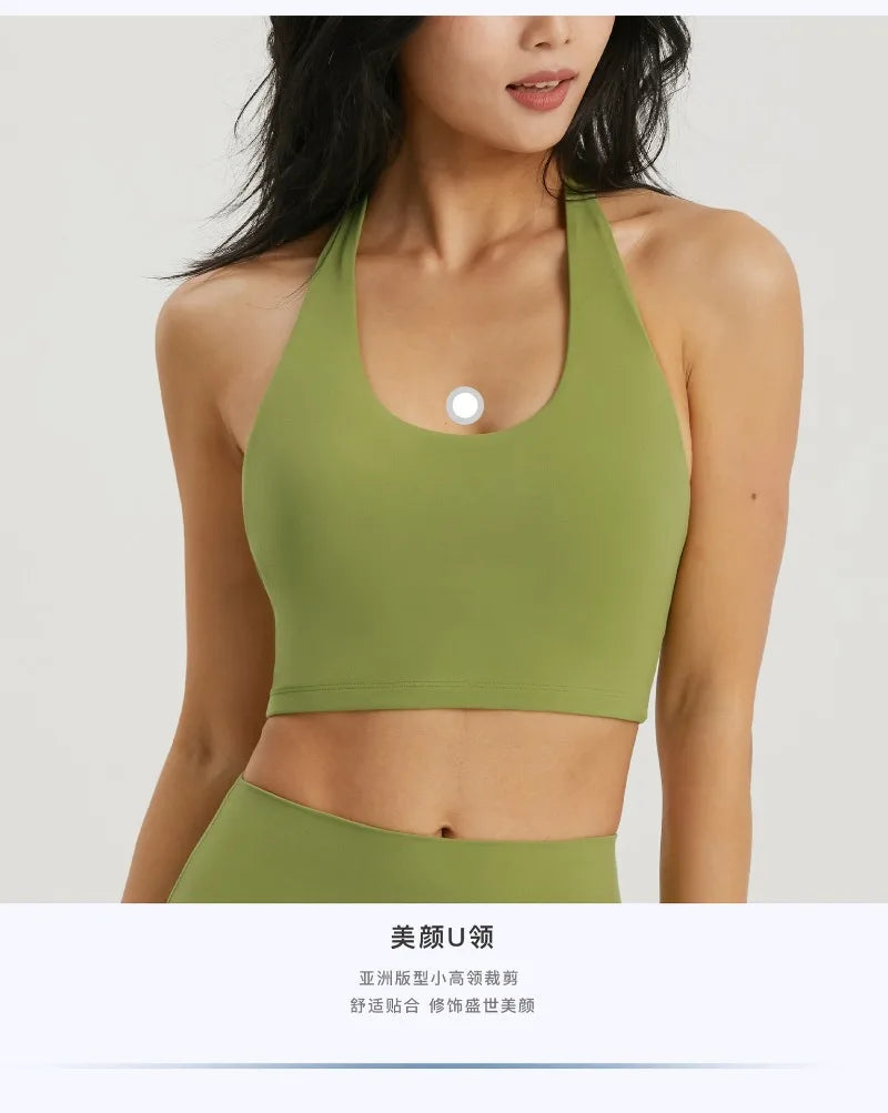 A model wearing a lime green halter neck sports bra top for yoga or gym activities.