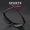 A pair of black sports sunglasses with a pink accent line displayed against a dark background.