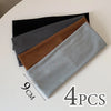 Four gray and brown elastic hairbands laid diagonally on a white surface.