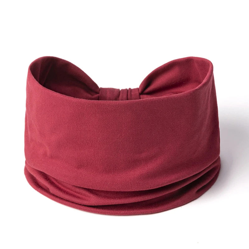 A maroon boho wide headband hair wrap for women shown flat lay.