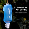 A light blue reusable water bottle with a hanging hole is shown against a dark green leaf background.