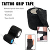 Roll of black self-adhesive tattoo grip tape with a needle applicator and a hand wrapped in the tape