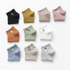 A collection of ten pairs of embroidered cotton socks in various muted colors and shades.