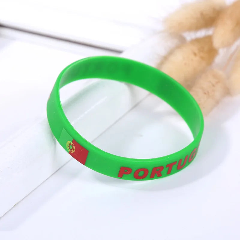 Green silicone wristband with the Portuguese flag emblem and the word PORTUGAL on a white background.