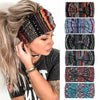 A woman wearing a black and multicolored bohemian cotton stretch headband with long blonde hair.