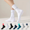 A variety of white and colored performance athletic running socks displayed on a foot.