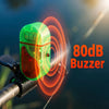 A green clip-on fishing bite alarm device with an orange sound wave emanating from it.