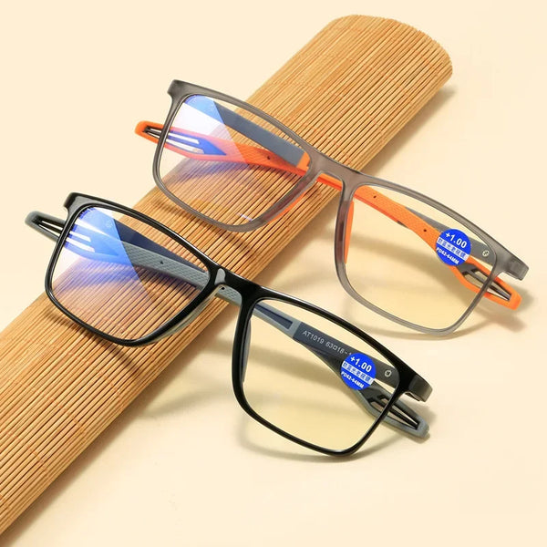 Une paire de lunettes de lecture carrées vintage avec des montures orange et une protection contre la lumière bleue, posée su