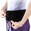 A person is adjusting a black compression support brace around their waist and thigh area.