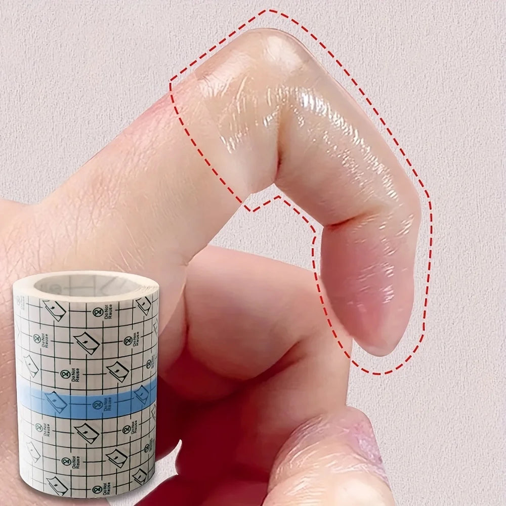 A hand is applying transparent self-adhesive tape around a finger for protection.