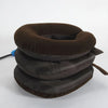 A stack of dark brown inflatable cervical traction stretchers or neck pillows.
