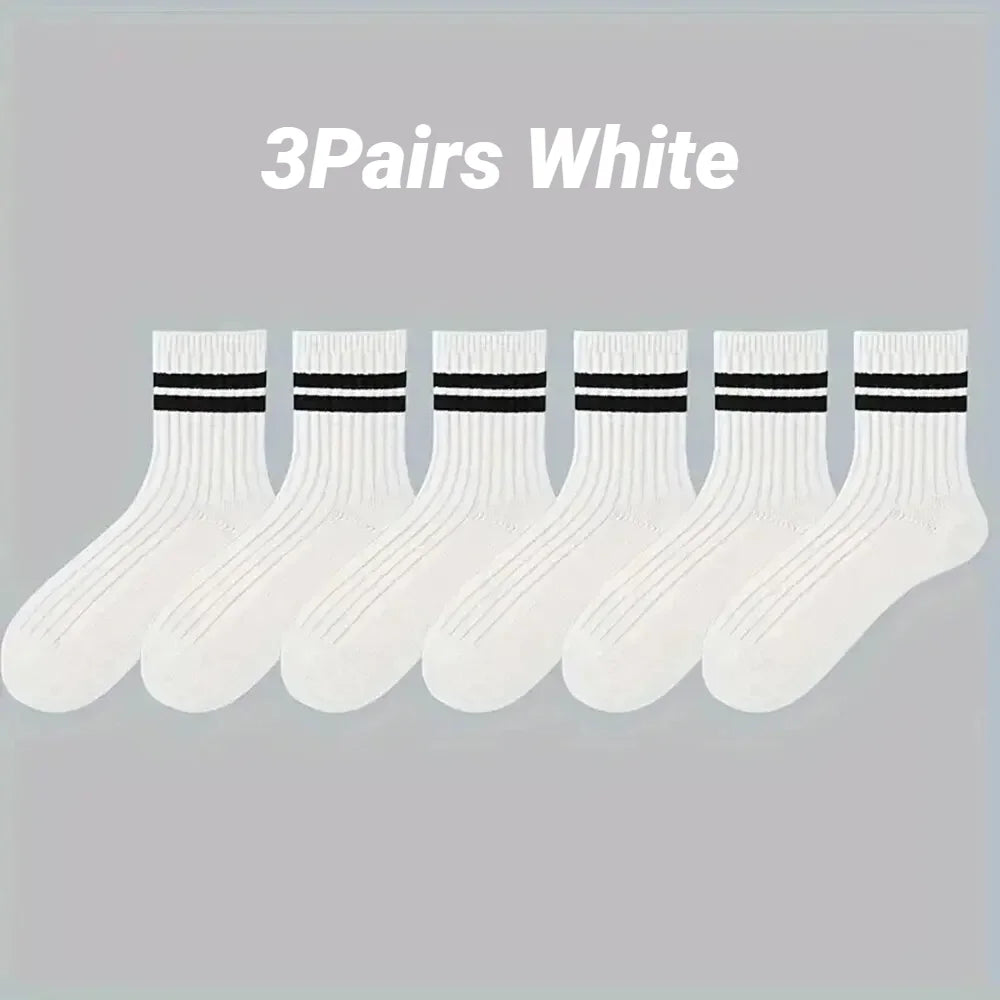Three pairs of white striped men's socks displayed in a row.