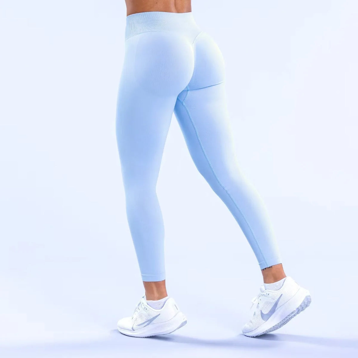 Light blue high-waisted seamless yoga leggings worn by a person.