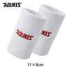 A pair of white towel wristbands with red logo text, measuring 11 by 8 cm.